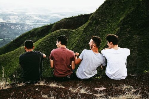 hostel friends traveling sitting on a mountain