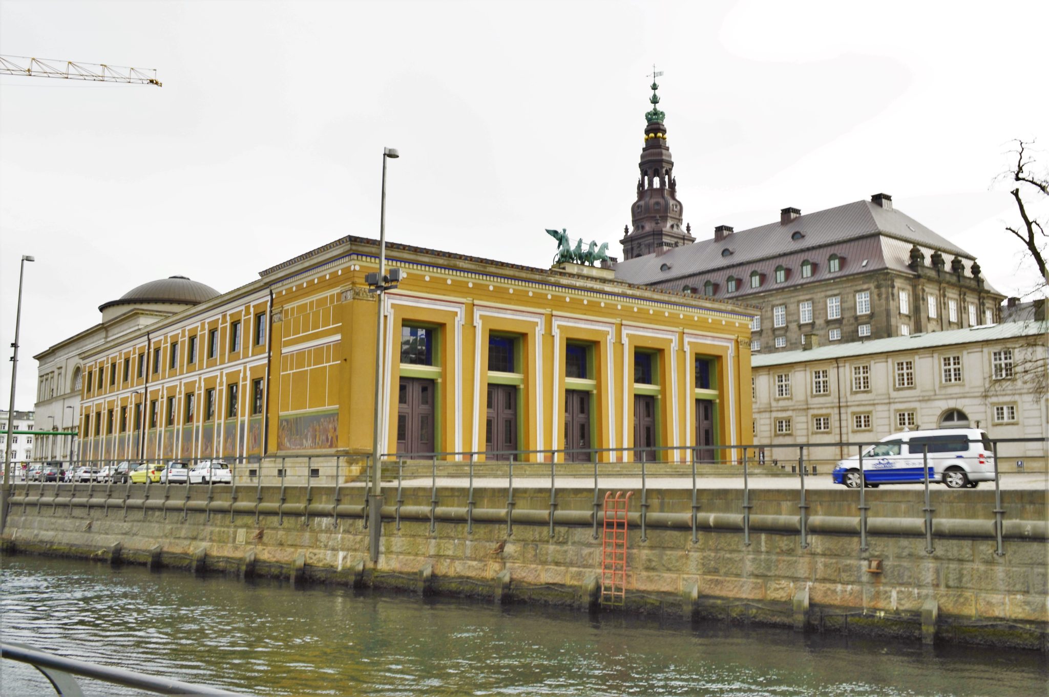 Yellow building by canal in Copenhagen, Denmark