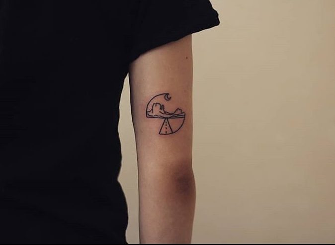 Back of the arm travel tattoo