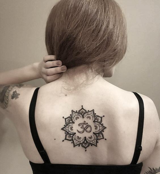 spiritual om tattoo top of back