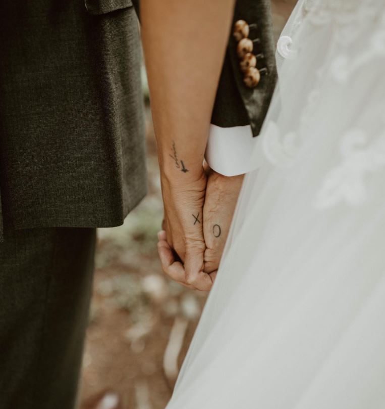 matching couple tattoo hand x o