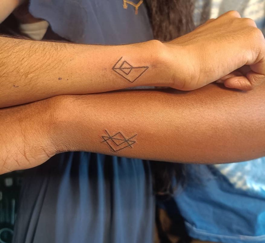 matching couple tattoos symbols forearm