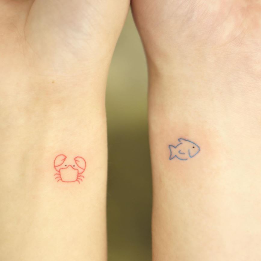 matching tattoos crab and fish