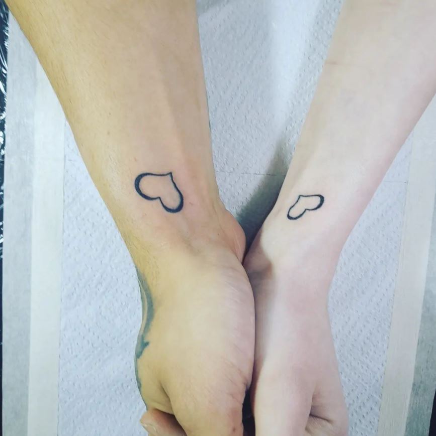 matching heart tattoos wrist couple